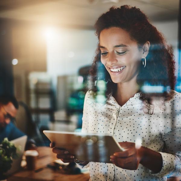 Woman with tablet smiling