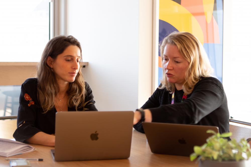 Zwei Frauen vor ihren Laptops 