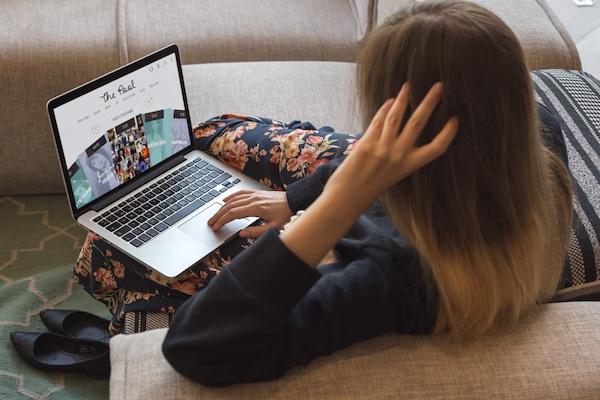 woman browsing the Pool website on her sofa
