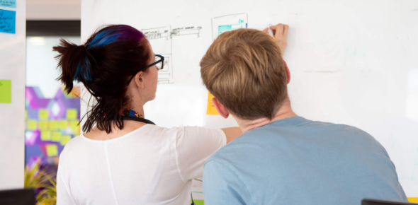 Daria & Stuart doing a brainstorm session on a whiteboard