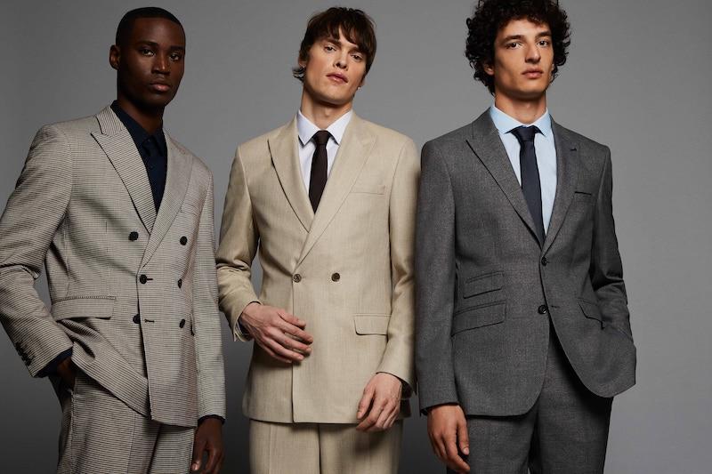 Three men modelling Burton clothing, part of Boohoo Group PLC